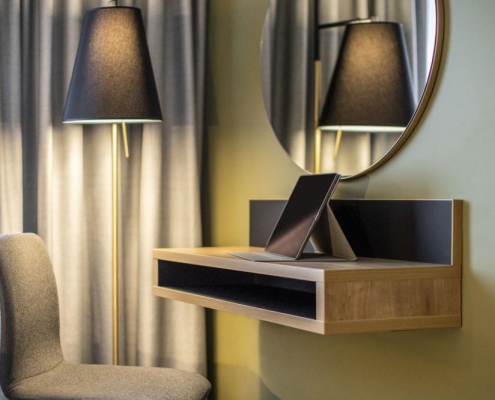 desk space and vanity mirror in modern hotel room